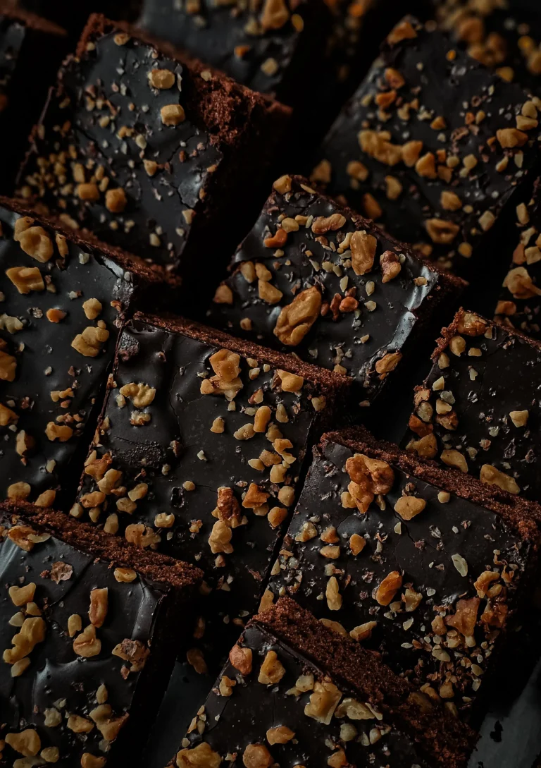 Rows of dark brownies topped with chopped nuts