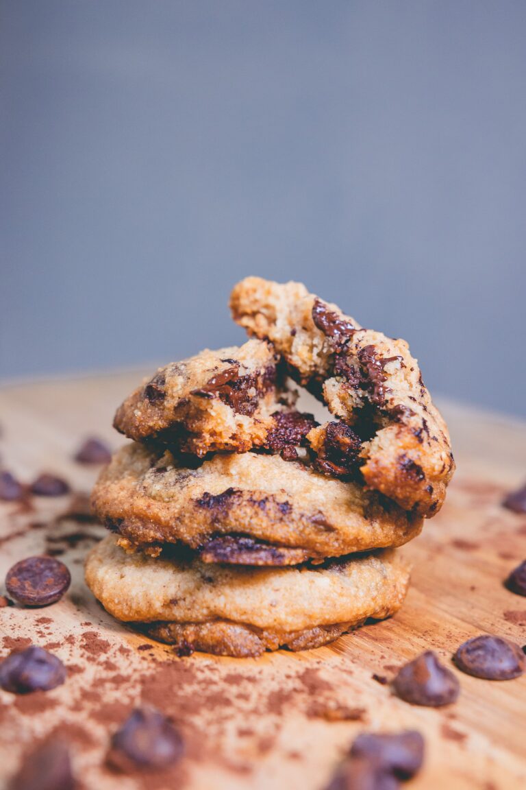A stack of chocolate chip cookies on a wooden board